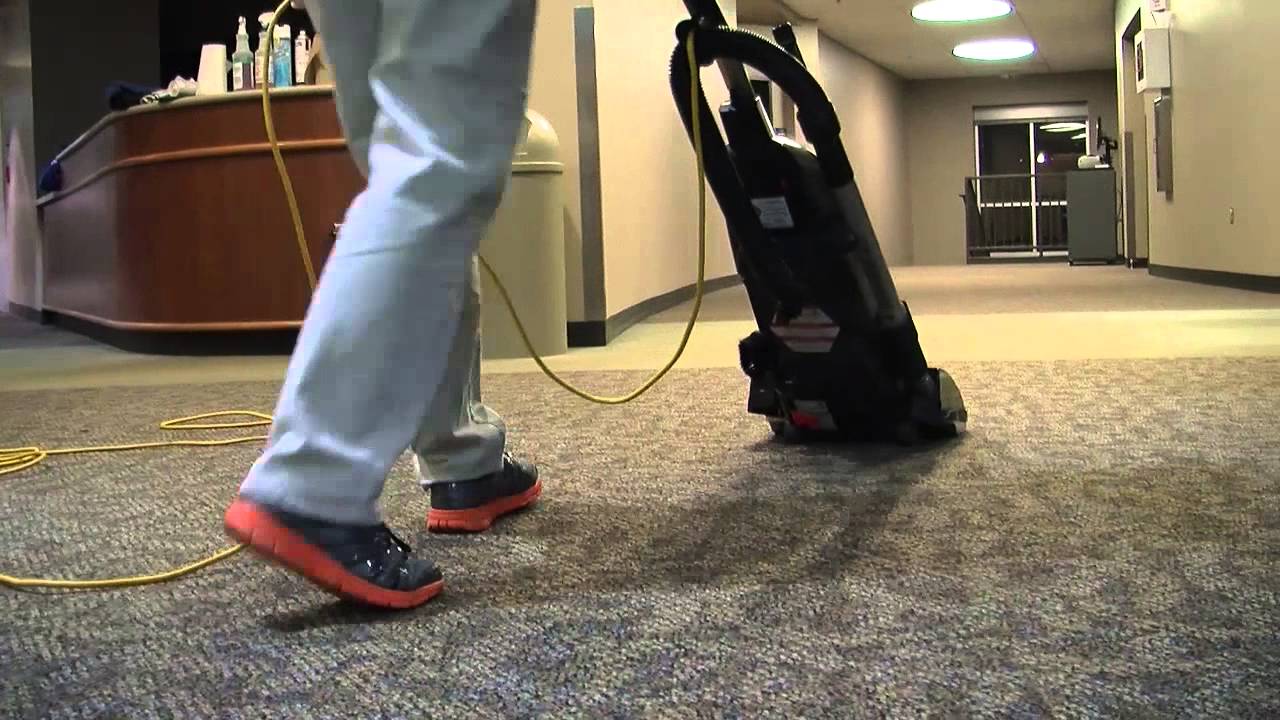 Office cleaning technician vacuuming carpet - commercial cleaning services and carpet cleaning in Greensboro North Carolina